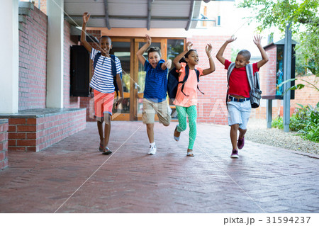 Classmates running at school corridor Classmates running at school corridor 31594237