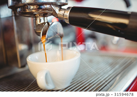Close-up of espresso maker pouring coffee at cafe Close-up of espresso maker pouring coffee at cafe 31594678