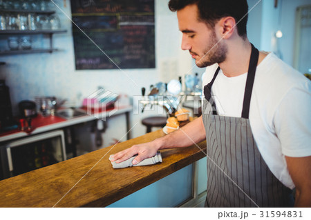 Handsome worker cleaning counter 31594831