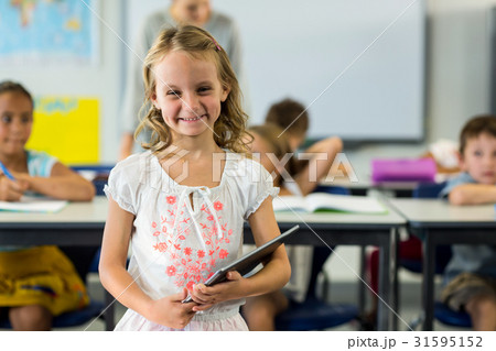 Cute girl holding digital tablet Cute girl holding digital tablet 31595152