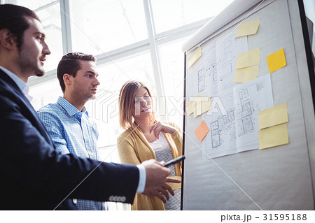 Business people looking at blueprints Business people looking at blueprints 31595188