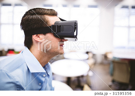 Side view of executive enjoying virtual reality headset at office 31595356