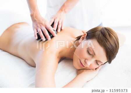 Beautiful woman enjoying hot stone massage 31595373