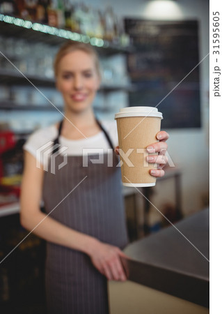Barista offering coffee cup at cafeteria 31595605