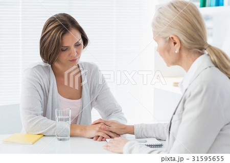 Therapist comforting her patient 31595655