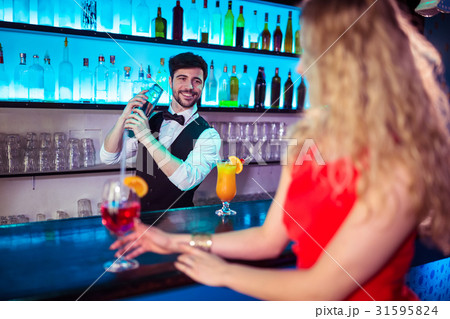 Bartender preparing cocktail for customer Bartender preparing cocktail for customer 31595824