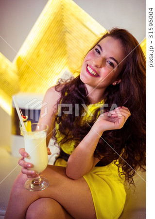 Portrait of happy woman enjoying drink in nightclub 31596004
