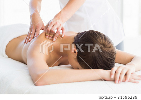 Naked Woman Receiving Back Massageの写真素材