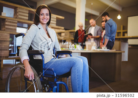 Confident disabled businesswoman by desk 31596502