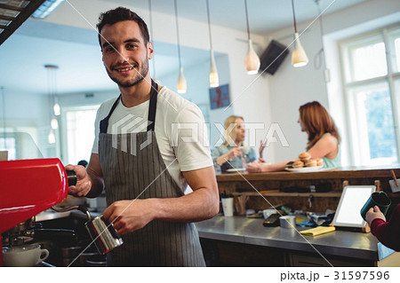 Portrait of happy barista at coffee shop 31597596