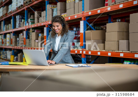 Business woman is talking with a headset 31598684