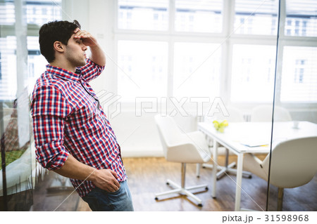 Upset businessman leaning on glass Upset businessman leaning on glass 31598968