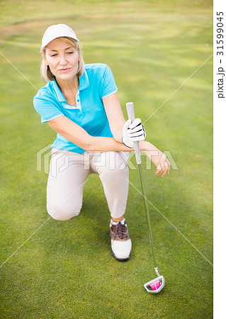 Golfer woman crouching on golf course Golfer woman crouching on golf course 31599045