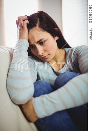 Depressed woman sitting at home 31599299