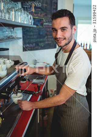 Portrait of confident barista using espresso maker at cafeteria 31599422