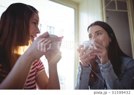 Happy female customers talking at cafe Happy female customers talking at cafe 31599432