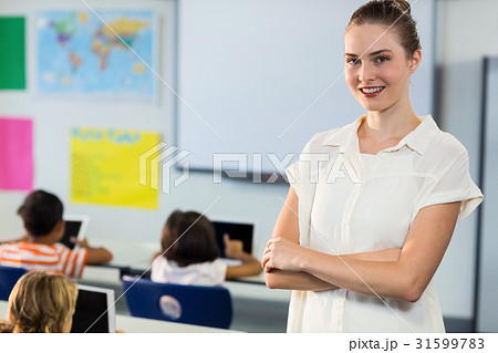 Female teacher standing with arms crosse 31599783