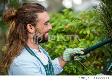 Happy gardener using hedge clippers at communicty garden 31599913