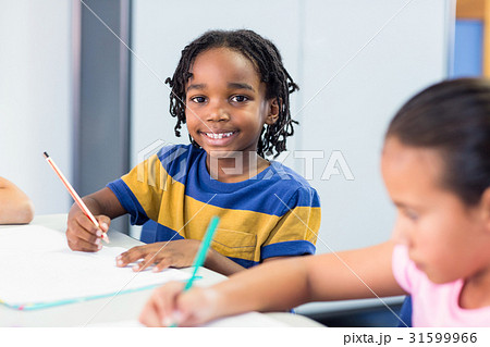 Schoolboy with classmate writing on book Schoolboy with classmate writing on book 31599966