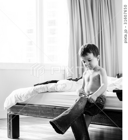 Liitle boy dressing and wearing his pants by himself 31607650