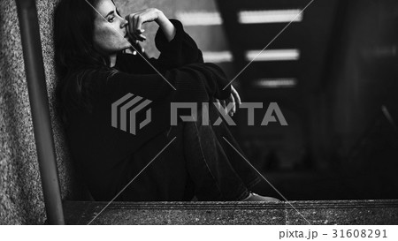 Adult Woman Sitting Look Worried on The Stairway Adult Woman Sitting Look Worried on The Stairway 31608291