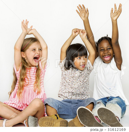 Diverse group of children sitting on the floor hands up Diverse group of children sitting on the floor hands up 31612169