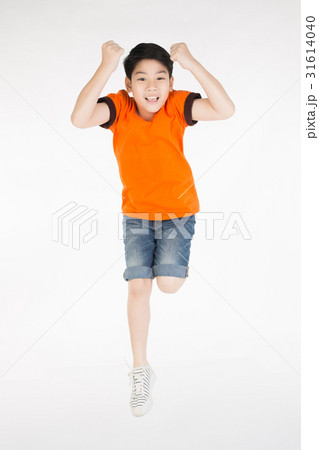 Asian cute boy is jumping with smile face Asian cute boy is jumping with smile face 31614040