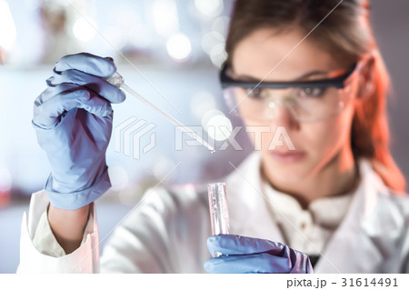 Young scientist pipetting in life science 31614491