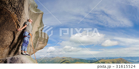 Male climber climbing big boulder with rope Male climber climbing big boulder with rope 31615524