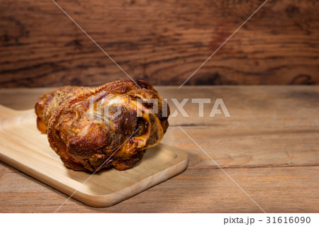 fried pork leg cooked on wood background fried pork leg cooked on wood background 31616090