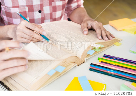 Young woman and man studying for a test/ an exam. 31620702
