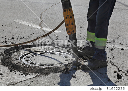 Asphalt demolishing, worker and jackhammer 31622226