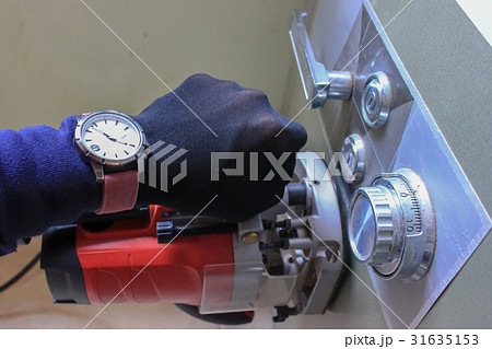 Hand and tools stealing a safety deposit box. Hand and tools stealing a safety deposit box. 31635153