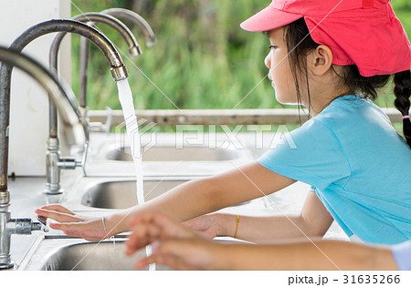 Asian girl is watching her hand with clean water Asian girl is watching her hand with clean water 31635266