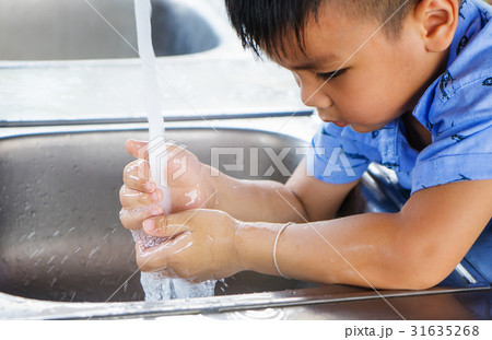 Asian boy is watching her hand with clean water Asian boy is watching her hand with clean water 31635268