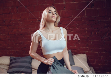 Sexy blonde woman with huge breast in a white tank Sexy blonde woman with huge breast in a white tank 31635622