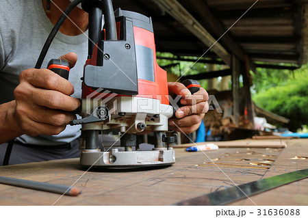 Electric routering to cut down stripes on the wood 31636088