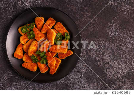 Chicken nuggets with sauces on dark background. 31640995