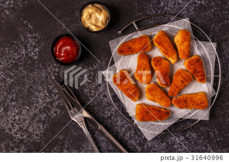 Chicken nuggets with sauces on dark background. Chicken nuggets with sauces on dark background. 31640996
