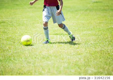 ジュニアサッカーの練習風景 ドリブルする少年の写真素材