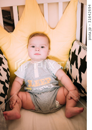 Cute little baby boy playing in colorful playpen 31642694