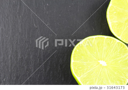 fresh lime fruit on a slate plate food background fresh lime fruit on a slate plate food background 31643173