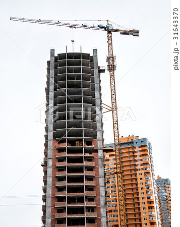 Crane near construction building. 31643370