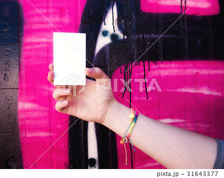 Female hand holding blank white business card. 31643377