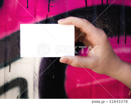 Female hand holding blank white business card. 31643378