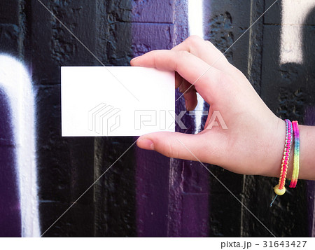 Female hand holding blank white business card. Female hand holding blank white business card. 31643427