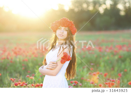 Young happy woman in poppy field 31643925