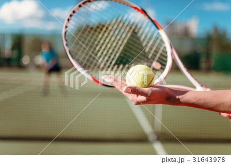 Female hands with ball and tennis racket Female hands with ball and tennis racket 31643978