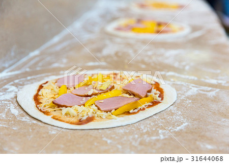 Pizza bases closeup, conveyor, food preparation  31644068