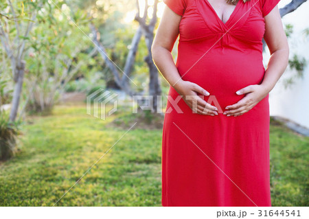 Beautiful pregnant woman relaxing outside in park 31644541